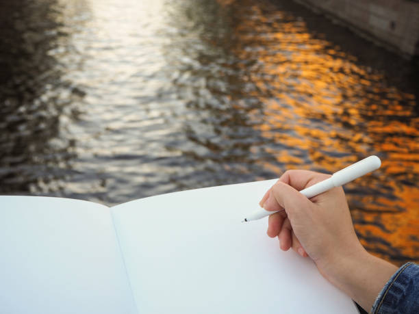 istock Mockup of person's hand holding blank white notebook preparing to write down his or hers ideas. 1191954127