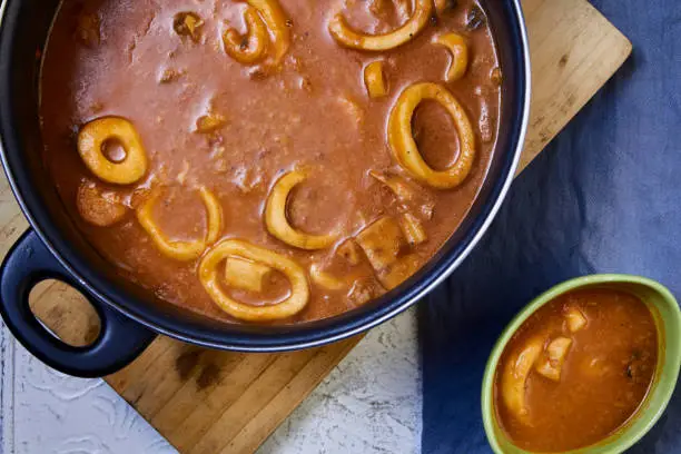 Photo of fish and seafood stew pot and bowl