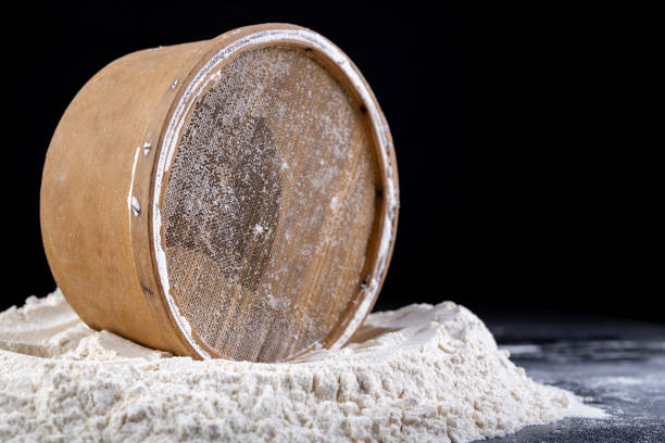 old wooden sieve prepared for sieving flour. kitchen accessories on the table in the home kitchen. dark background. - old fashioned domestic kitchen old close up imagens e fotografias de stock