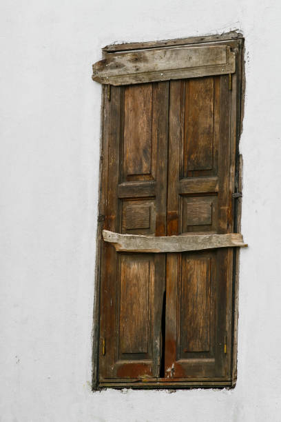 istock white wall and old wooden windows and locks 1191960943
