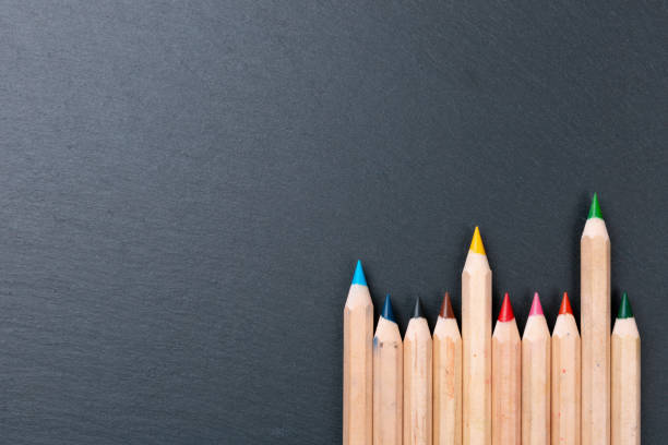 istock Color pencils on chalkboard background, copy space 1191963307