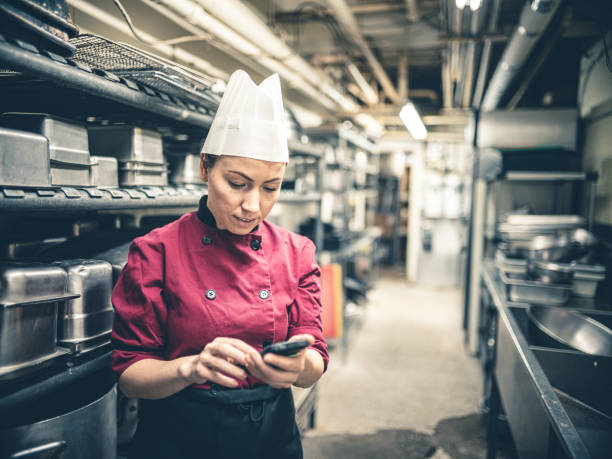 istock Female Chef with mobile phone 1191965853