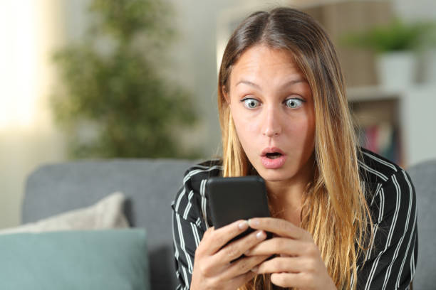 istock Surprised woman finding amazing content on phone 1191967061