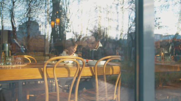 istock Outside the window son and father in cafe 1191968502
