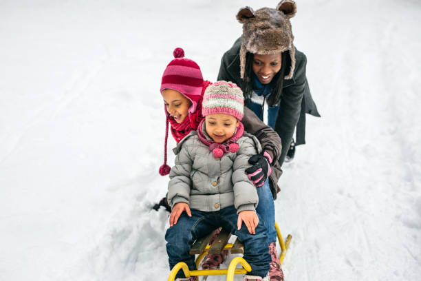istock Single mom playing with kids at snow 1191970329