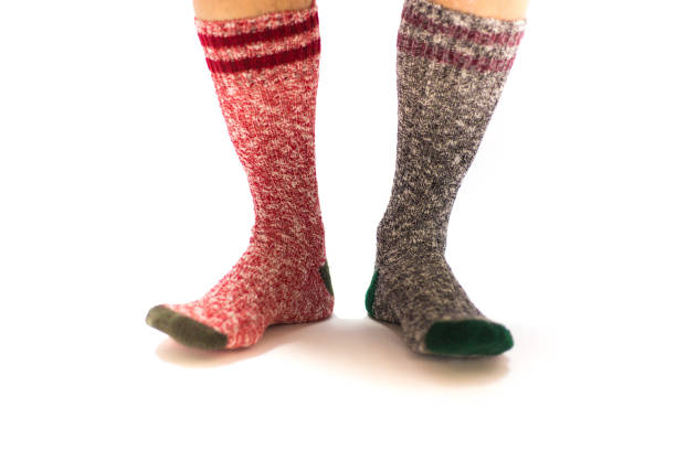 istock Man's Feet in Funny Mismatched Socks, White Background 1191971185
