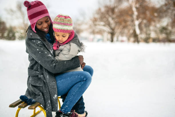 istock Mother and daughter playing in snow 1191971404