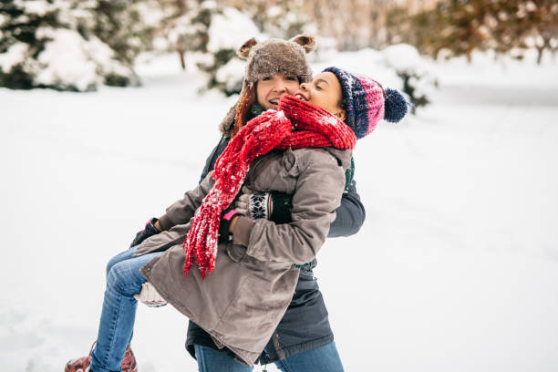 istock Mother and daughter playing in snow 1191971615