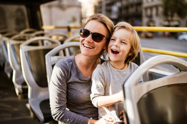 istock Happy mother and son riding in double-decker bus 1191973528