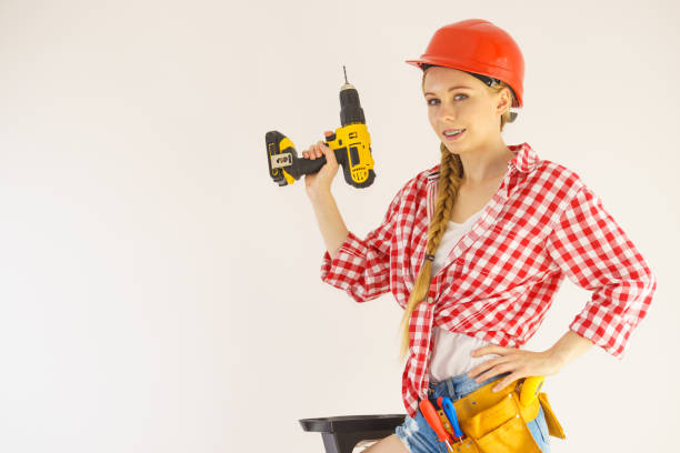istock Woman wearing helmet using drill 1191976380