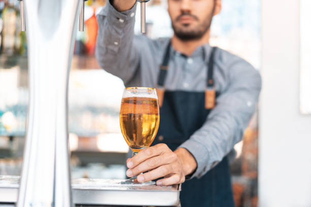 Bartender working on drinks and alcohol establishment