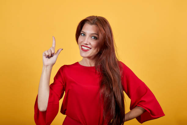 istock Pretty lady intending to realize the solution while lifting up a finger. 1191984778