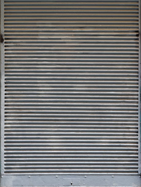 istock Old weathered steel roller shutter door 1191988904