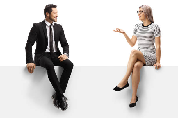 istock Young businessman and a young lady having a conversation while sitting on a panel 1191990164