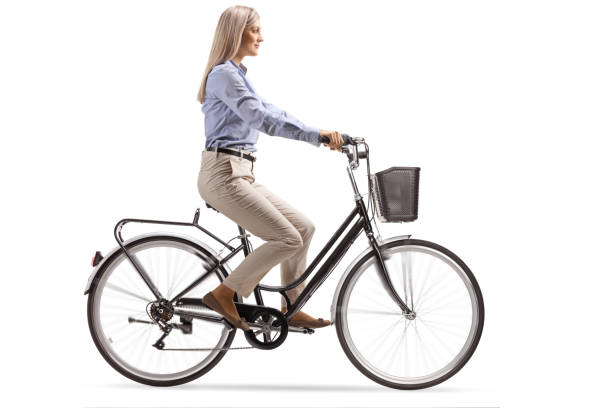 istock Young woman in formal clothes riding a bicycle 1191990174