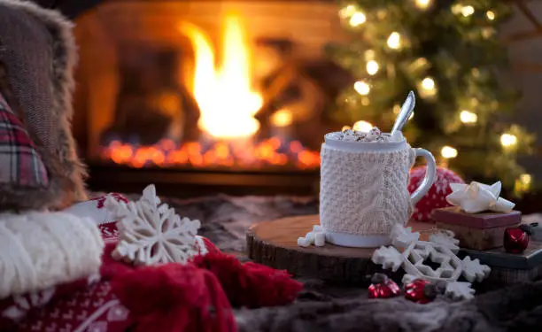Photo of Christmas cozy hot chocolate in front of the fireplace