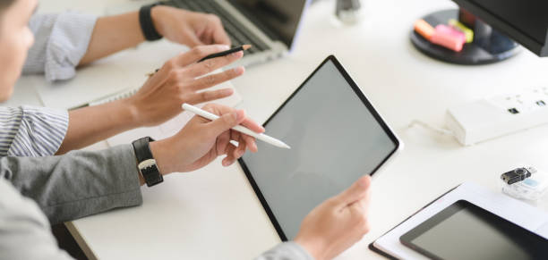 istock Cropped shot of young professional UX web developer team working on their project together 1191996533