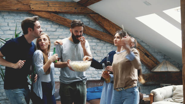 istock Girl feeding her friend with popcorn 1191999648