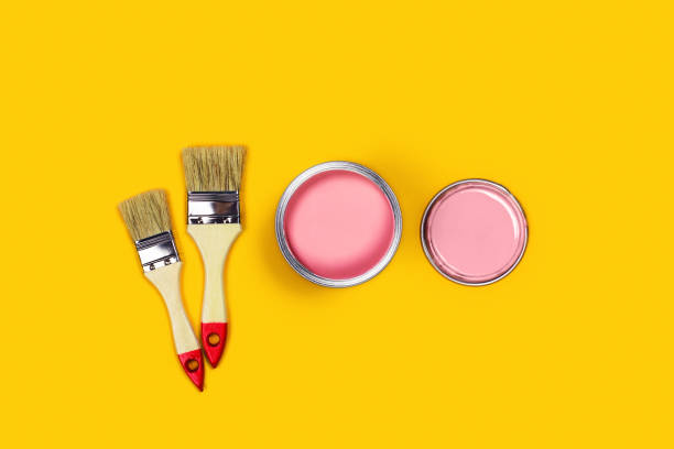 istock Colored background with paint jar and brushes. 1191999745