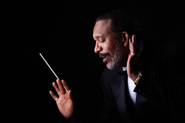 istock Mature man in tuxedo with baton 1191999964