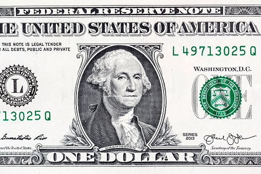 Close-up portrait of George Washington on a US 1 dollar banknote.