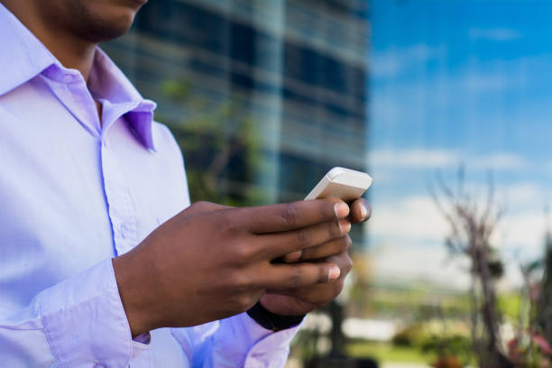 istock Latin businessman using mobile phone in the city. 1192004549