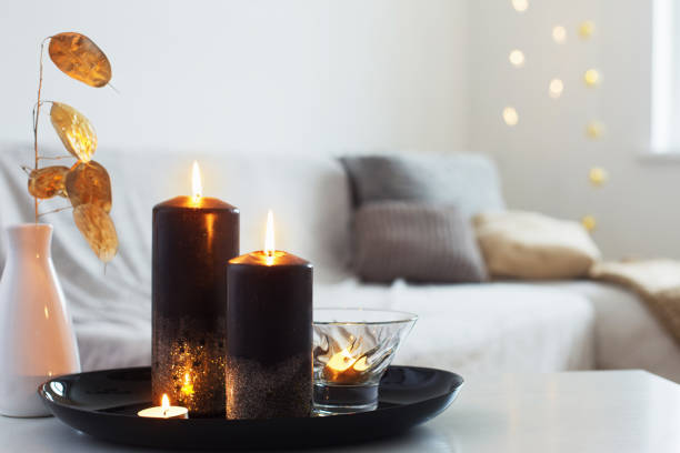 istock black and golden candles on white table 1192007768
