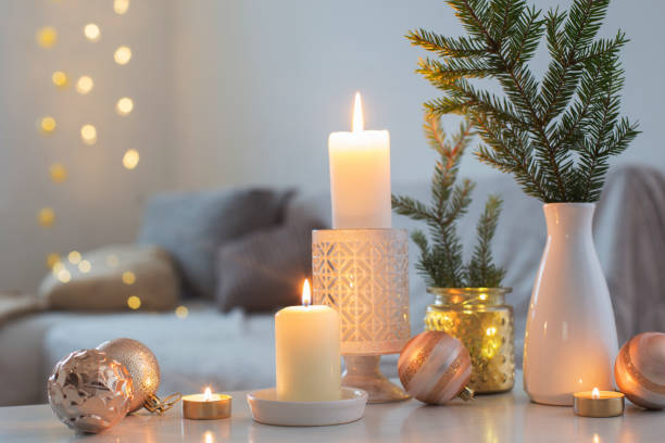 istock Christmas decorations with burning candles in white interior 1192007829