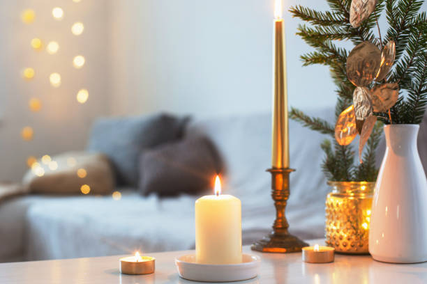 istock Christmas decorations with burning candles in white interior 1192007831