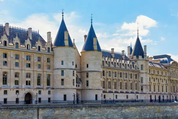 View of the Conciergerie castle in Paris, France. It formerly a prison and it was part of the former royal palace. Hundreds of prisoners were taken from the Conciergerie to be executed by guillotine.