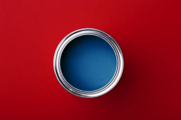 istock Can of blue paint on red. 1192012778