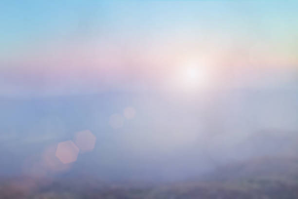 istock Natural background blurring warm colors and bright sun light. Bokeh or Christmas background Green Energy at sky sunny color orange light patterns plain abstract flare evening clouds blur. 1192014993