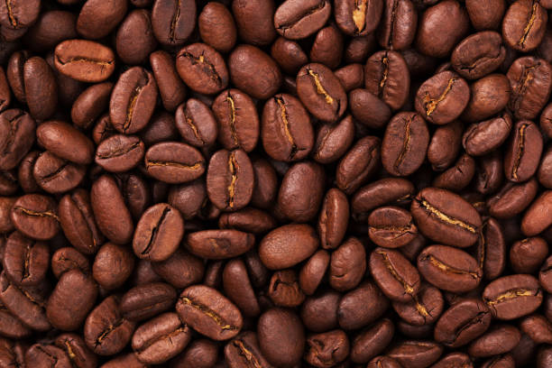 istock fresh Roasted coffee beans closeup. Background textured 1192023255