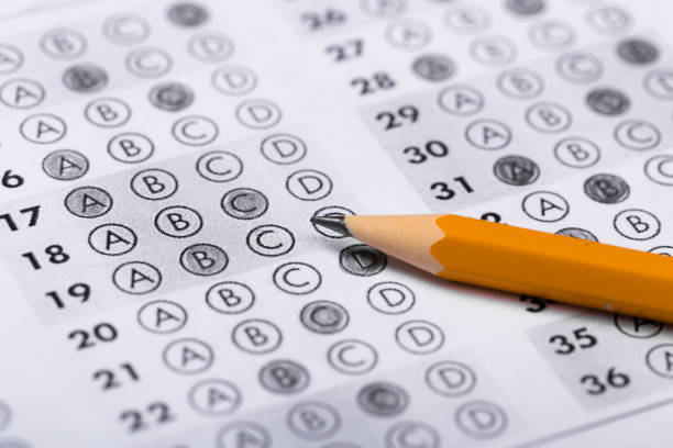 istock testing in exercise and exam paper. computer sheet with pencil in school test room, education concept 1192023401