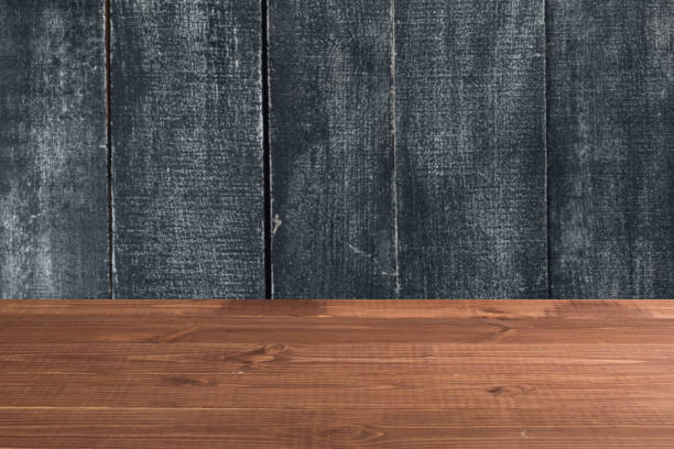 istock Wooden board empty table in front of a blurred background. Perspective brown wood over blurred wooden planks background - can be used to showcase or assemble your products. Mock up 1192023408