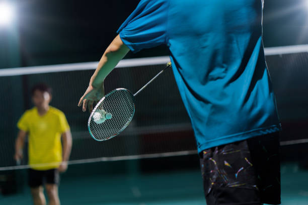 istock Asian badminton player is hitting in court 1192023517