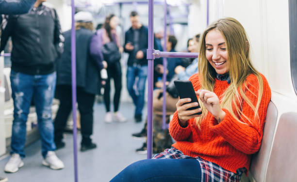 istock Young woman texting in the subway train 1192024745