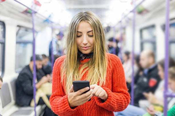 istock Young woman texting in the subway train 1192024747