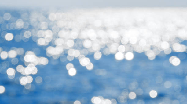 istock Sea in the sunlight. Blurred calm blue water bokeh background 1192026776