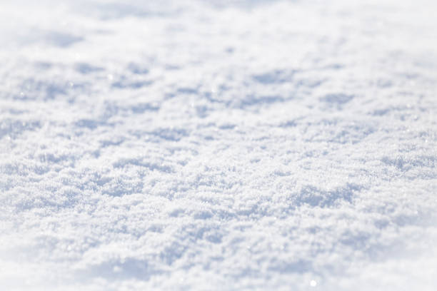 istock Background of sparkling fresh white snow texture with light blue sky reflection tone. 1192026853