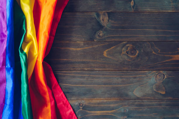 istock Rainbow flag or LGBT flag on brown wooden table 1192028618