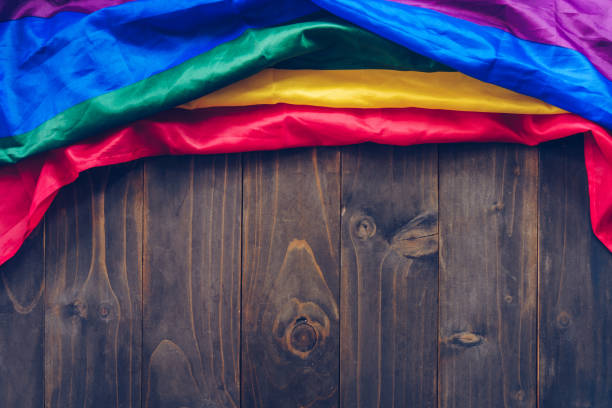 istock Rainbow flag or LGBT flag on brown wooden table 1192028639