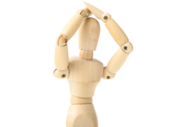 Wooden figure having a headache on white background