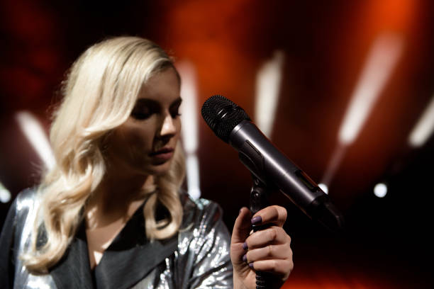 istock Singer woman on stage. Singer and microphone. 1192030022
