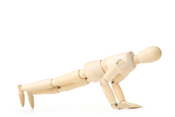 istock Wooden figure doing exercises on white background 1192030115