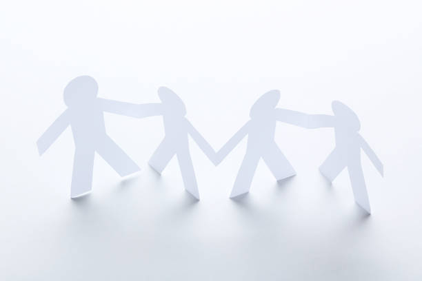 istock Paper chain people on white background 1192033681