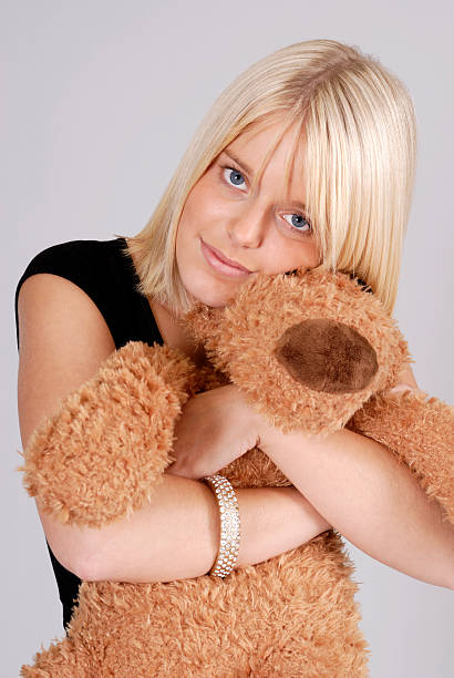 istock beautiful young blond woman with teddy bear 119203465