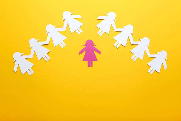 istock Paper chain people on yellow background 1192034898