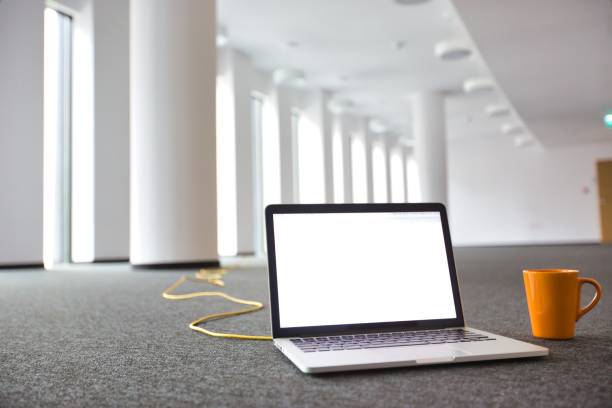Laptop on the floor at new empty office