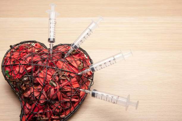 heart syringe wooden table background